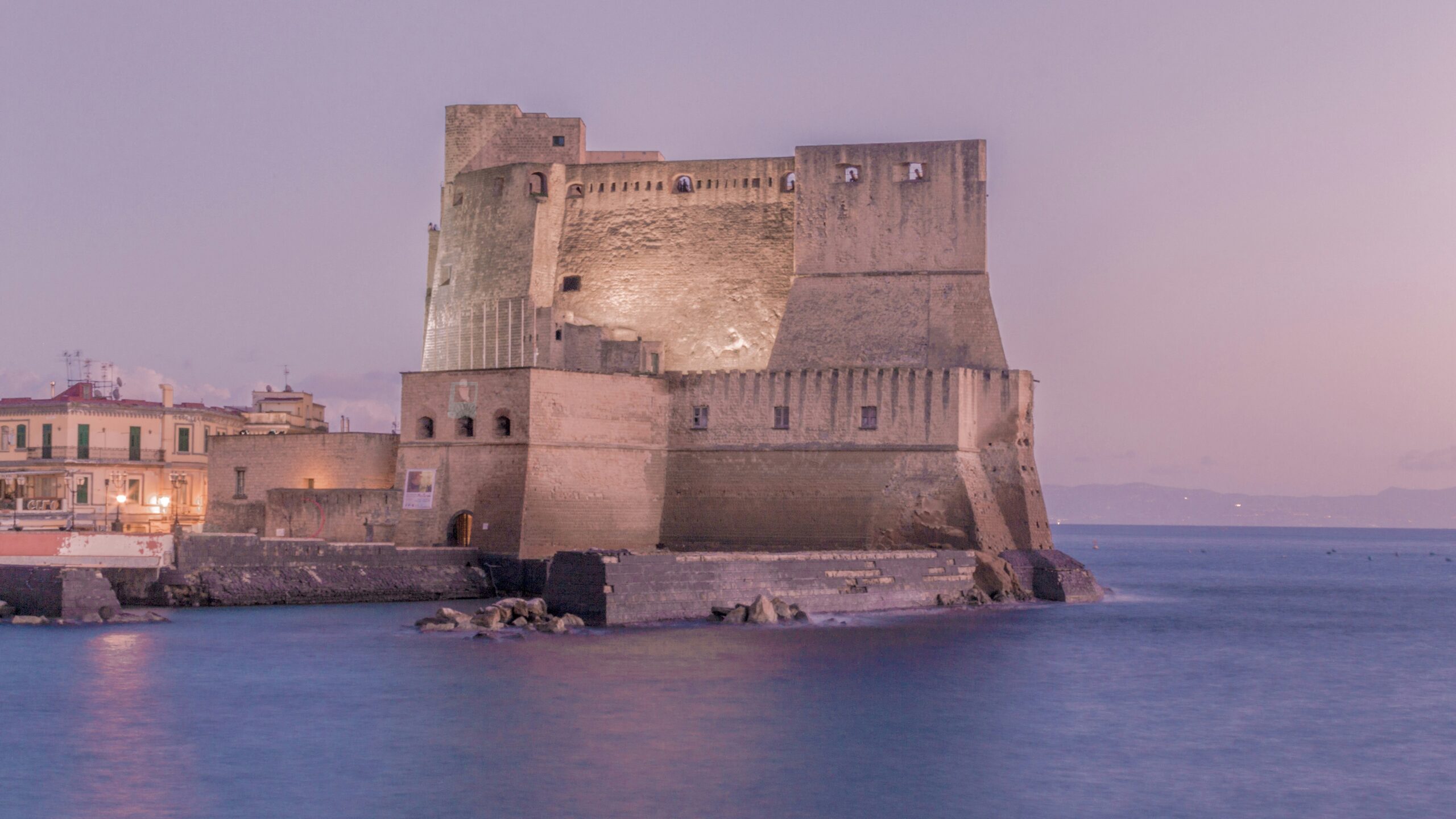 Castel dell'Ovo seafront castle in Naples at dusk