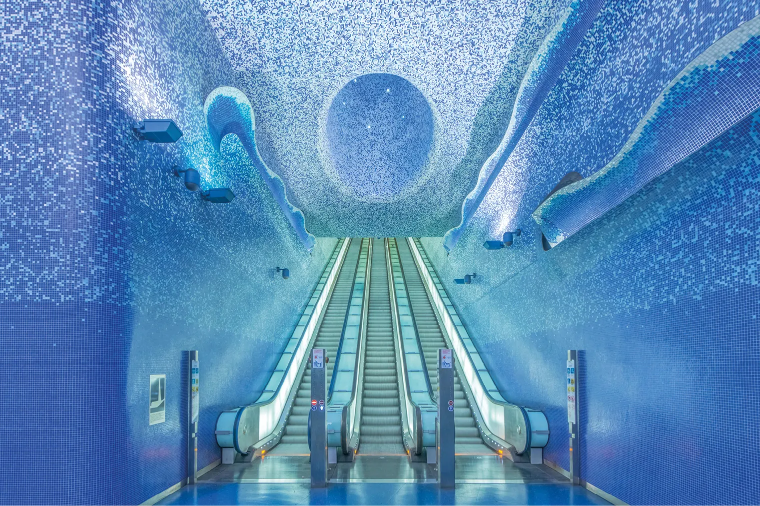 Toledo metro station in Naples with its blue mosaic Crater de Luz above the escalators