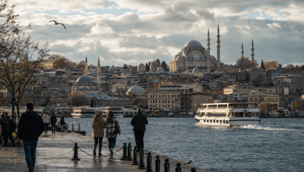 Istanbul waterfront in cool transitional weather with a ferry crossing and Suleymaniye catching the sun