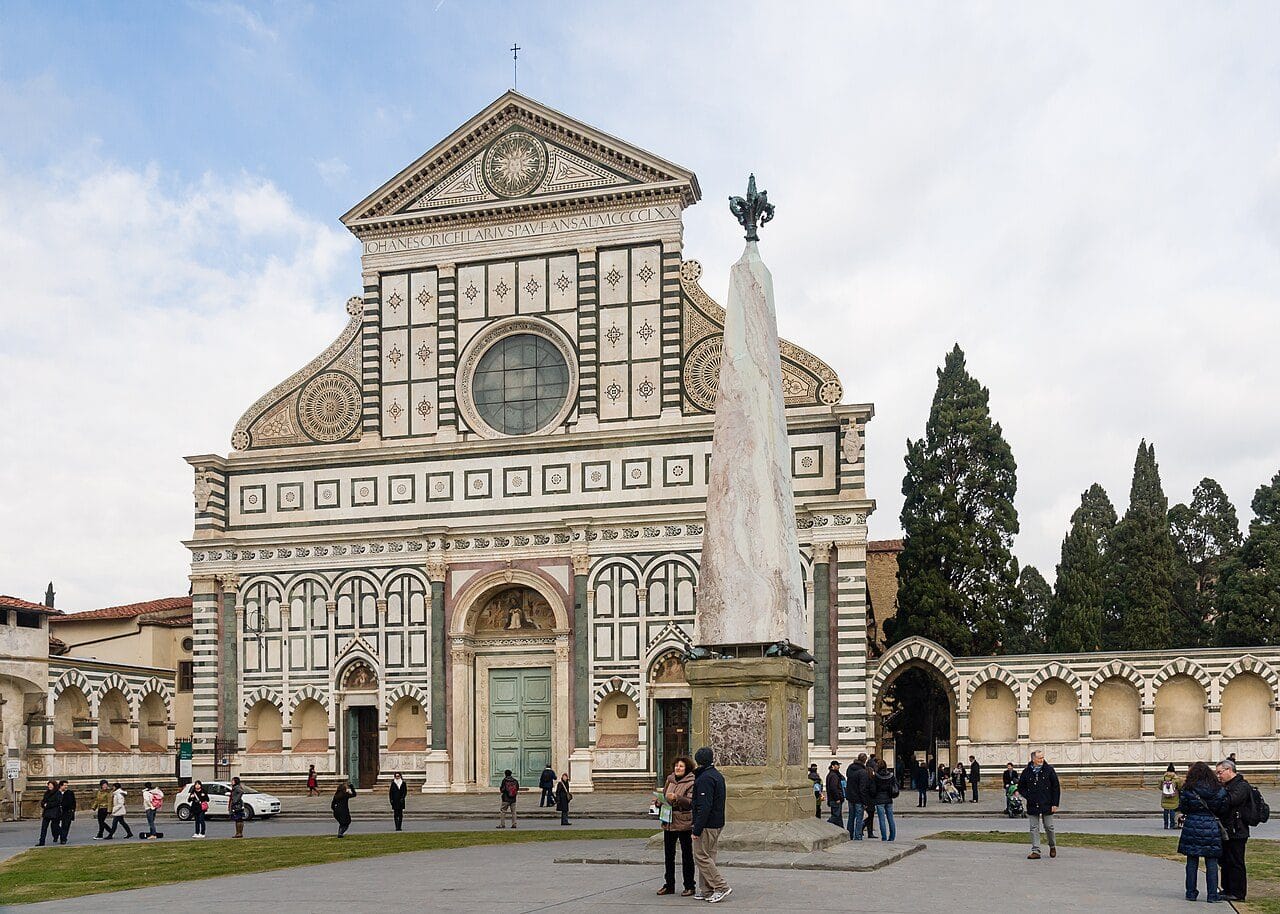The green and white marble facade of Santa Maria Novella across its piazza, with the marble obelisk in the foreground