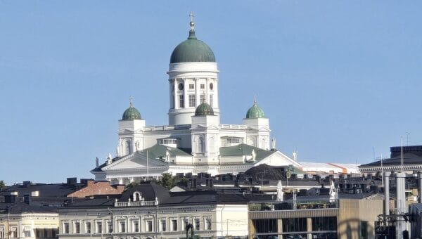 Helsinki Cathedral rising above the city waterfront on a sunny morning, seen from the water